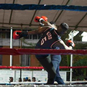 Two boxers fighting in a ring, one landing a powerful punch to dominate the opponent