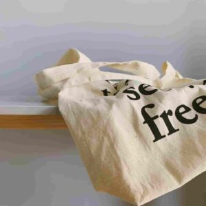 Eco-friendly reusable cotton tote bag placed on a wooden table